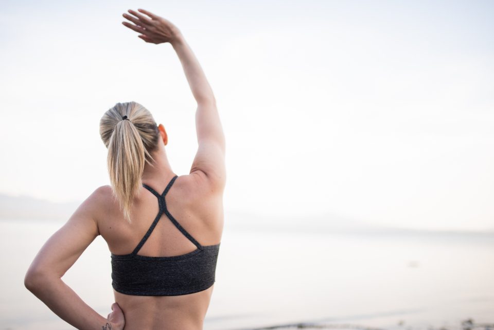Woman stretching her shoulder outdoors