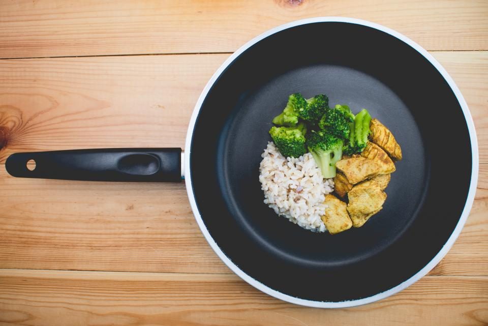 Pan with rice, broccoli and chicken seen from above