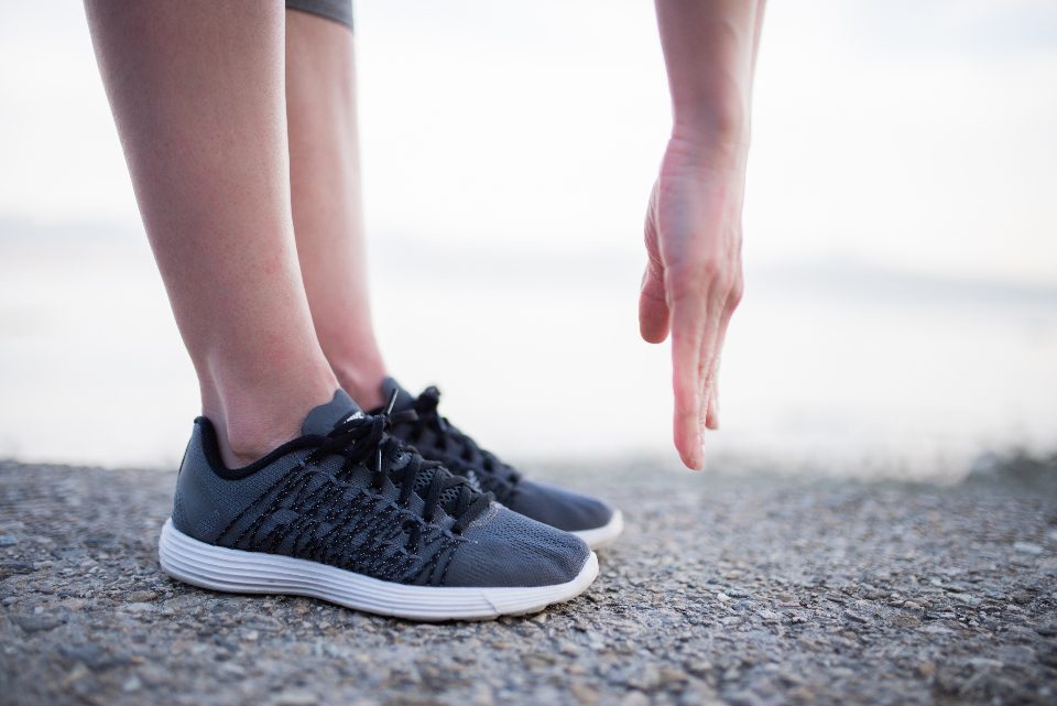 Person standing in grey running shoes