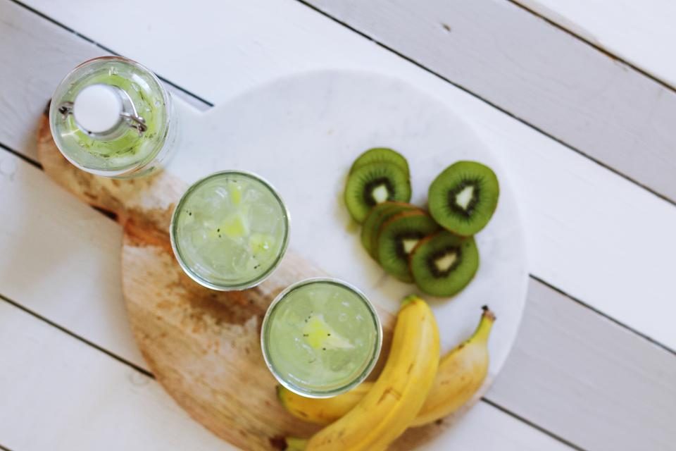 Infused water with lime and kiwi on a white board